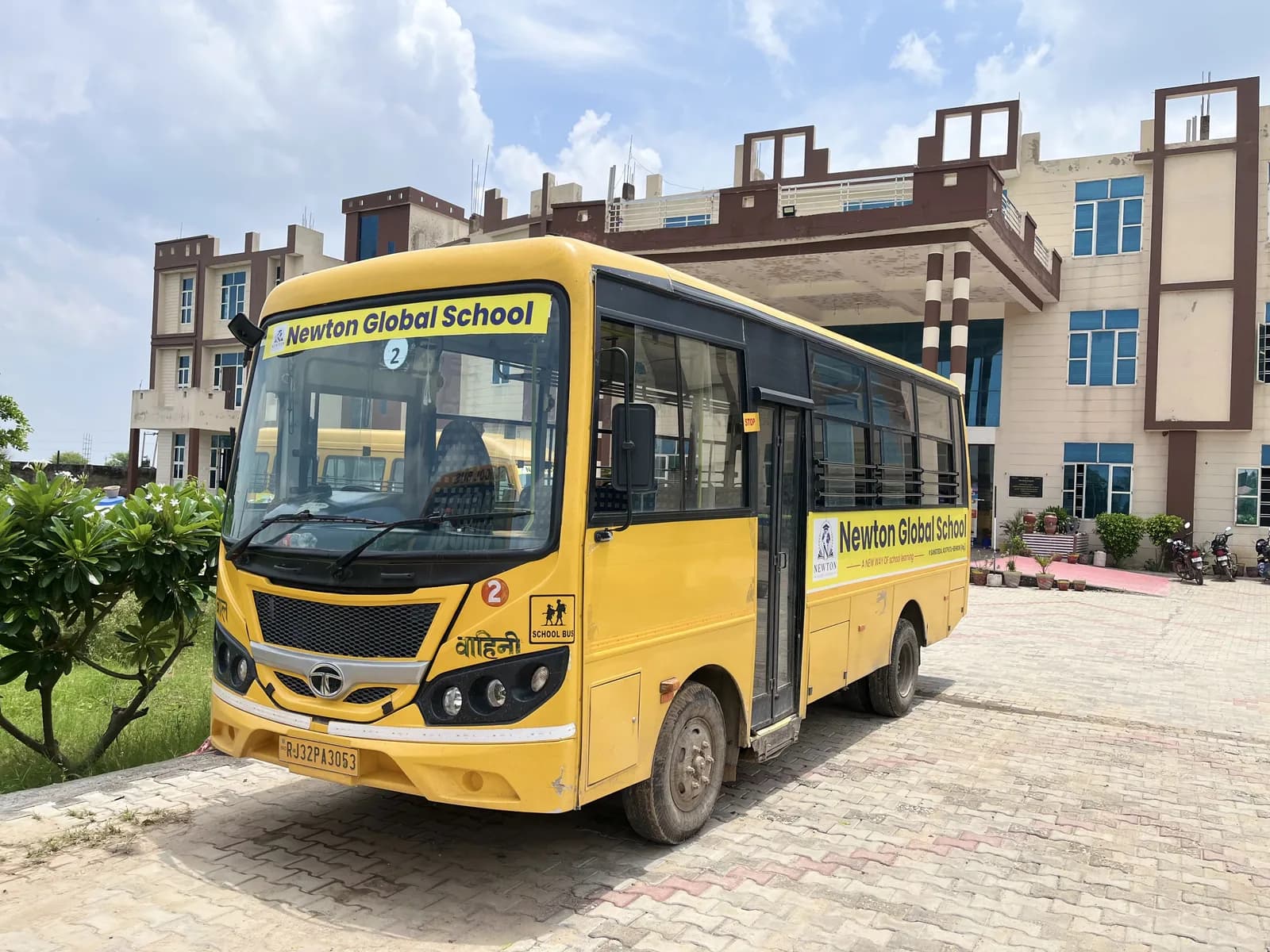 A Newton Global School bus outside the main building