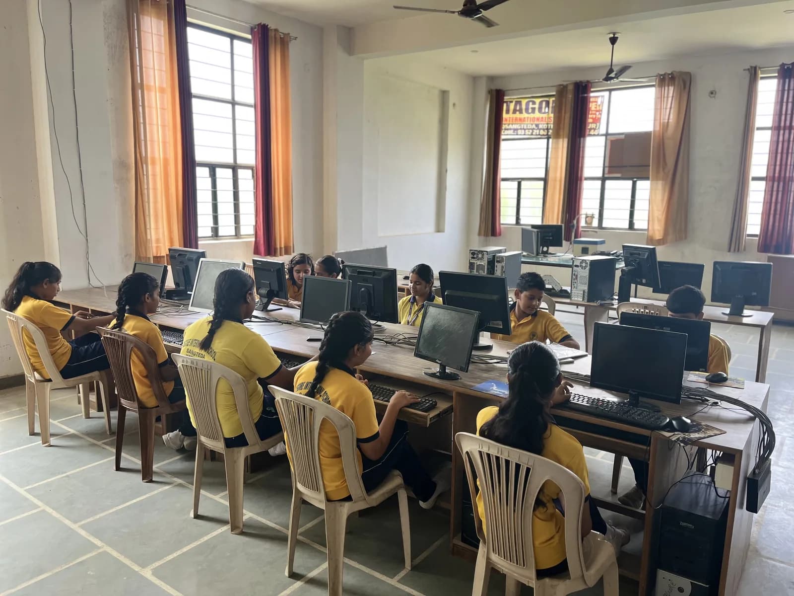 Pupils working at computers in the school lab
