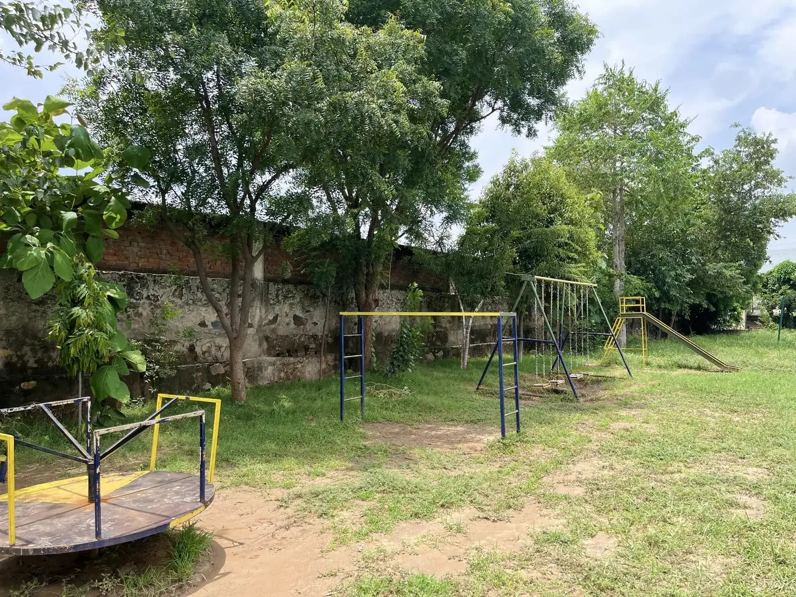The school playground with swings and open ground