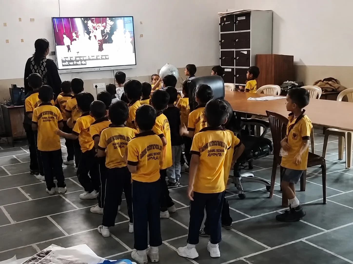 A class watching a lesson on the smart classroom screen