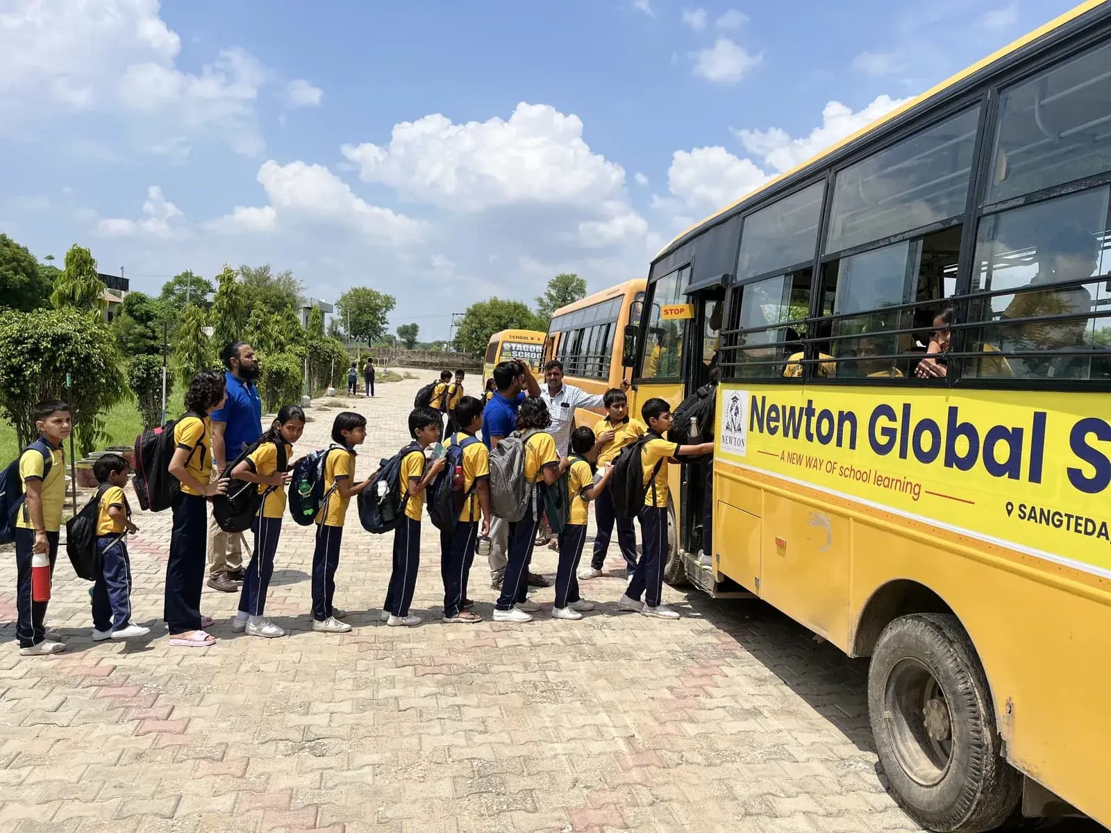 Pupils lining up to board the school bus